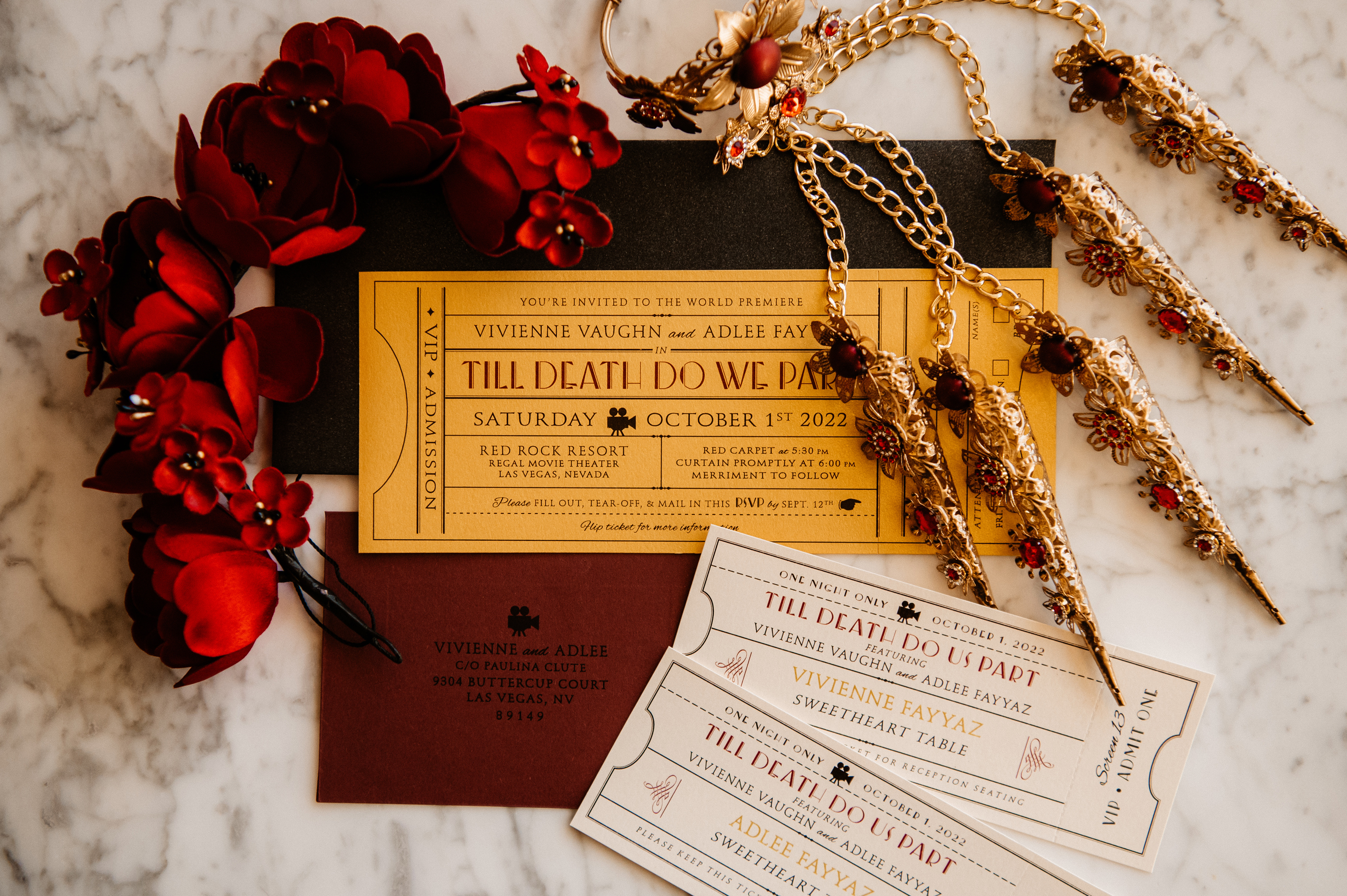 A wedding invitation suite featuring a gold ticket with event details for a film premiere titled 'Till Death Do We Part'